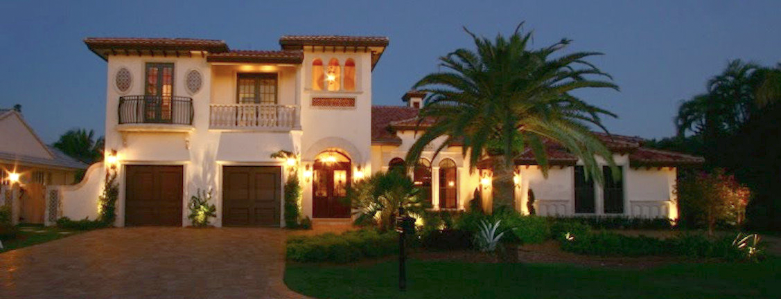 Royal Palm Yacht Club custom home exterior at dusk