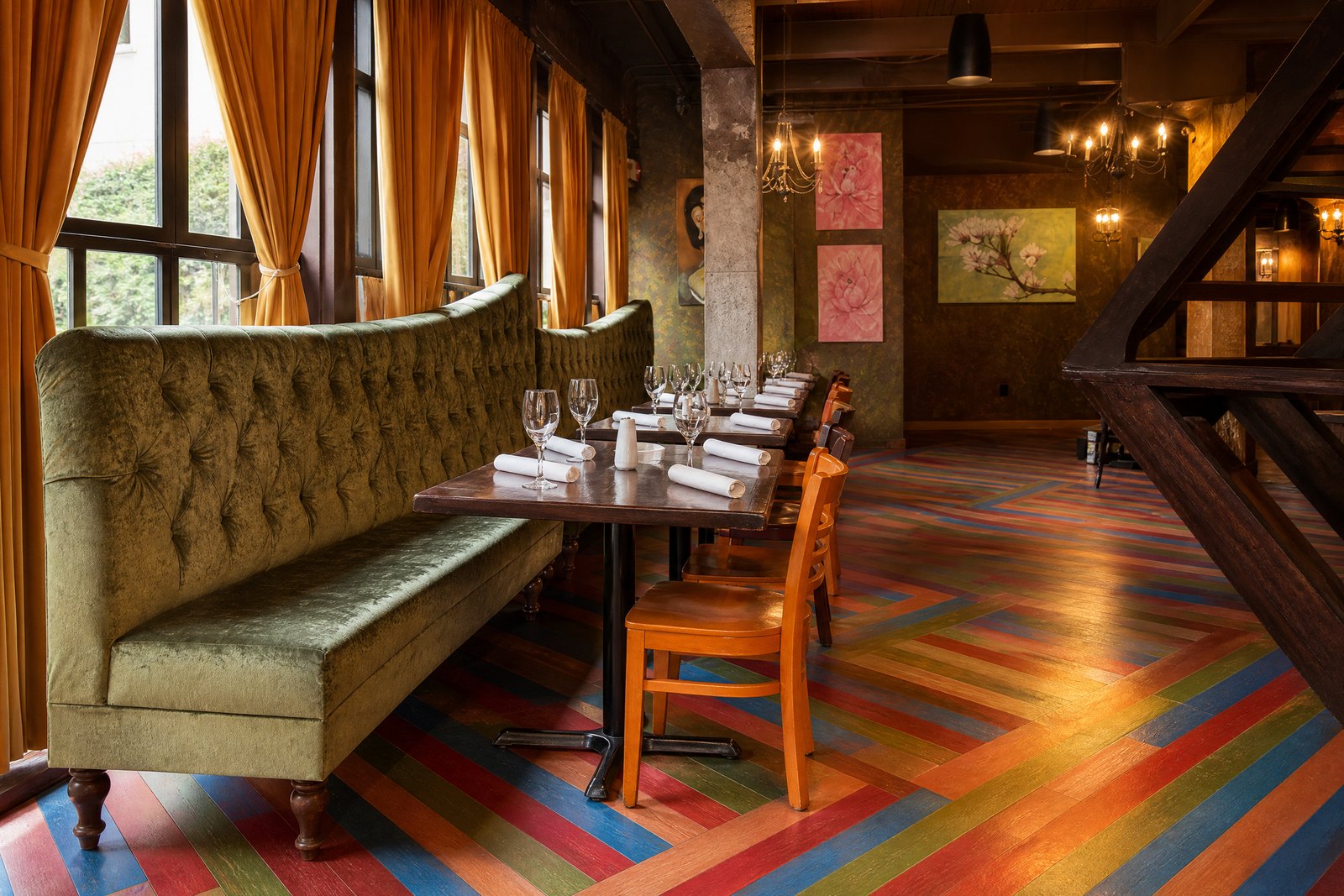 Santiago’s Bodega dining room with green banquette and multicolored geometric floor