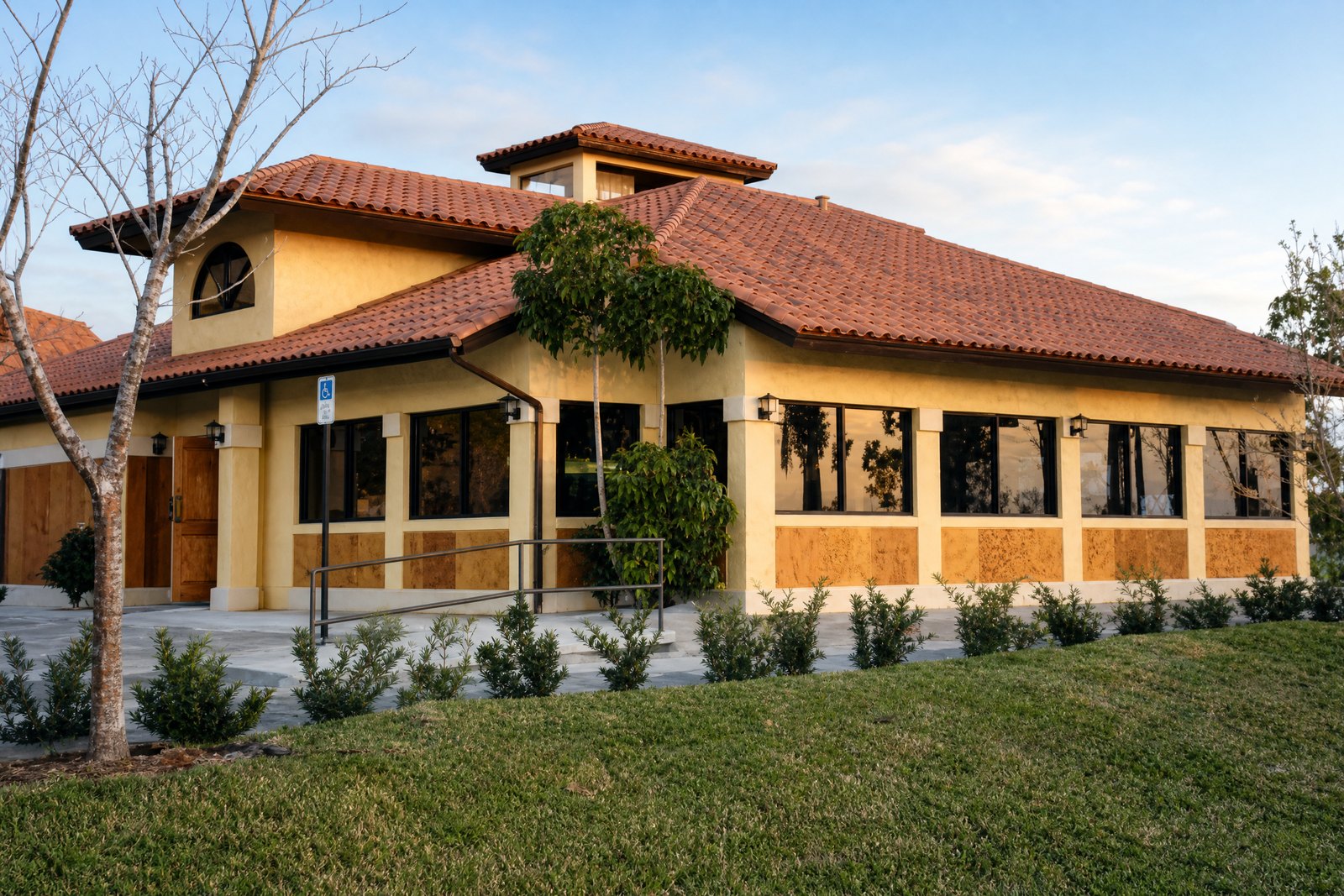 Tom’s Ribs exterior with yellow stucco, clay-tile roof and covered walkway